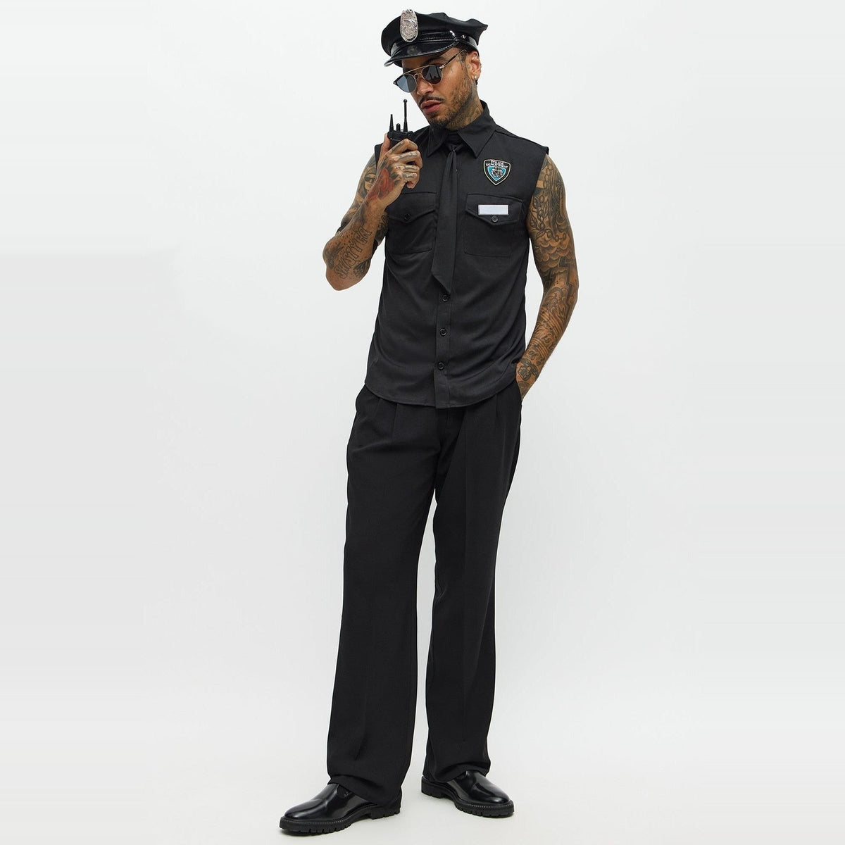 Man wearing black police costume with sleeveless shirt, hat, and badge | Chaps London