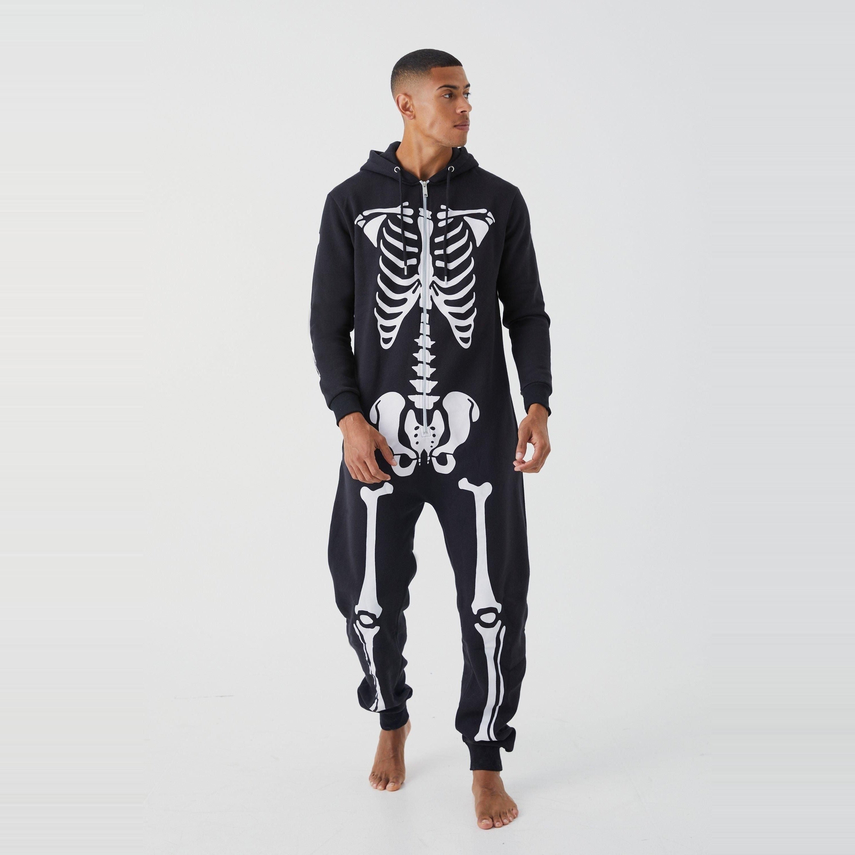 Man wearing black hooded skeleton onesie with white bone print, standing | Chaps London
