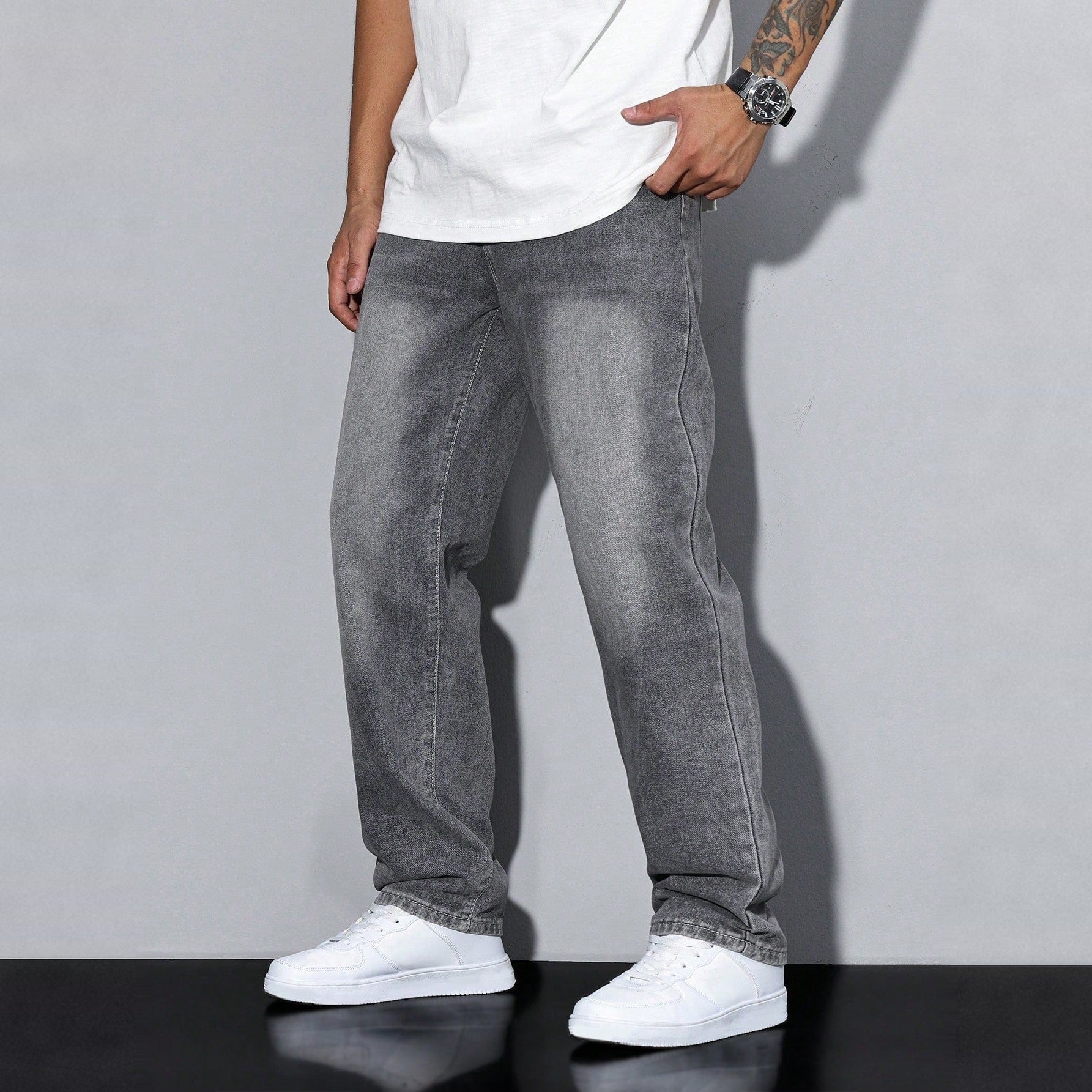 Man wearing gray washed wide-leg denim jeans with white sneakers and shirt | Chaps London