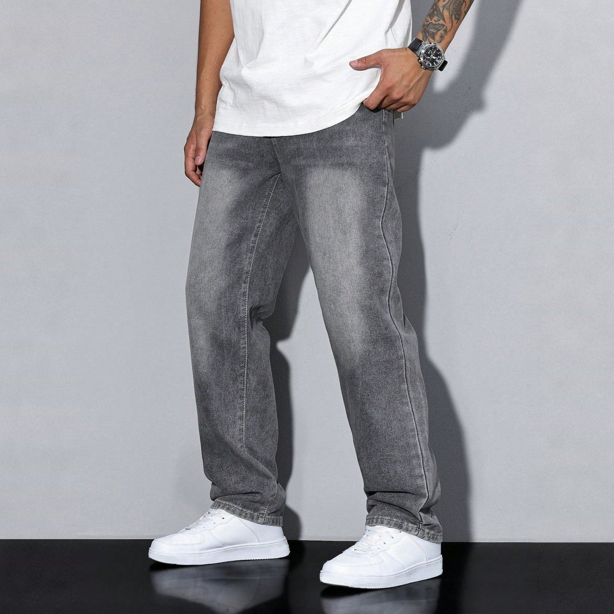 Man wearing gray washed wide-leg denim jeans with white sneakers and shirt | Chaps London
