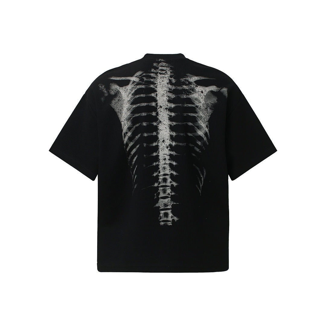Black oversized t-shirt with spine skeleton print, shown flat, back view | Chaps London