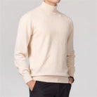 Man wearing cream knit turtleneck sweater with black trousers, side view | Chaps London