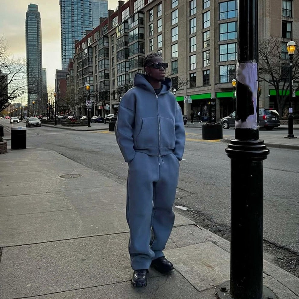 Man wearing gray oversized zip hoodie and wide leg joggers outdoors | Chaps London