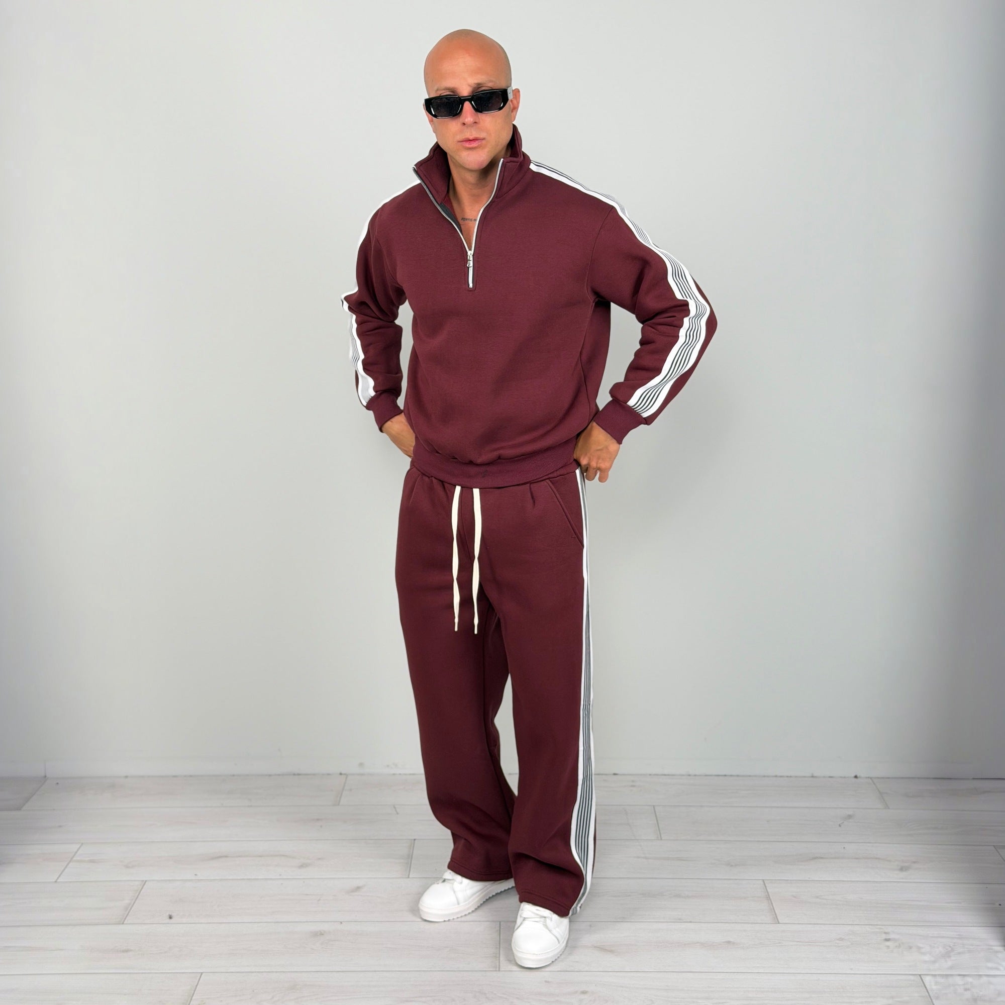 Man wearing burgundy striped half zip tracksuit with wide leg trousers | Chaps London