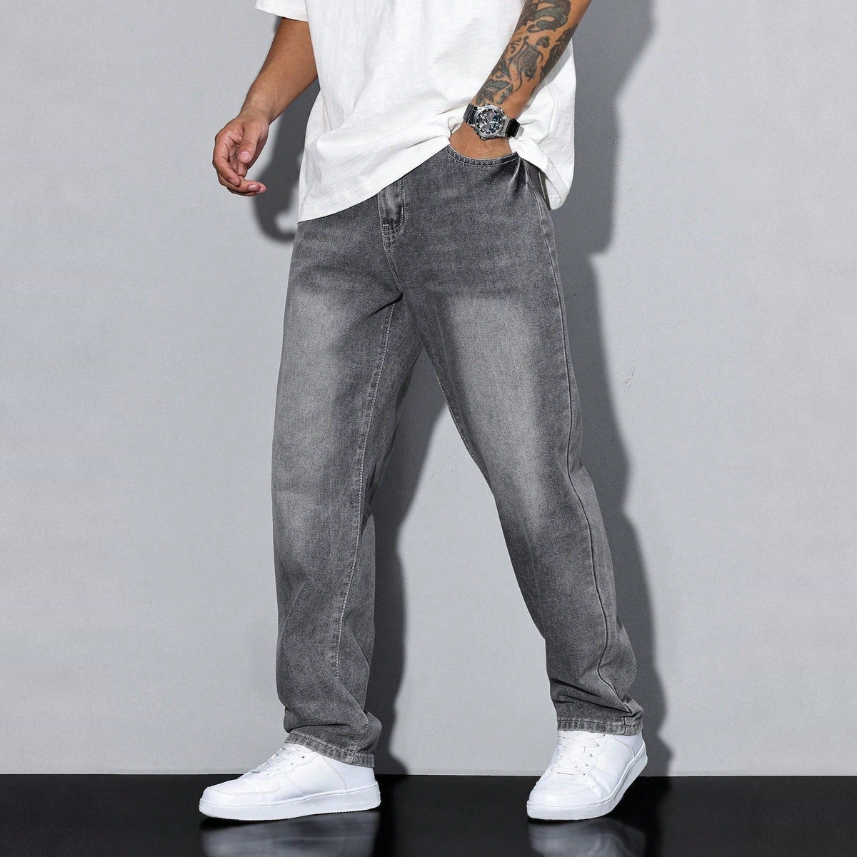 Gray washed wide-leg denim jeans worn by man, white sneakers | Chaps London