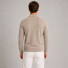 Man wearing beige quarter zip polo jumper, worn, rear view, white trousers | Chaps London