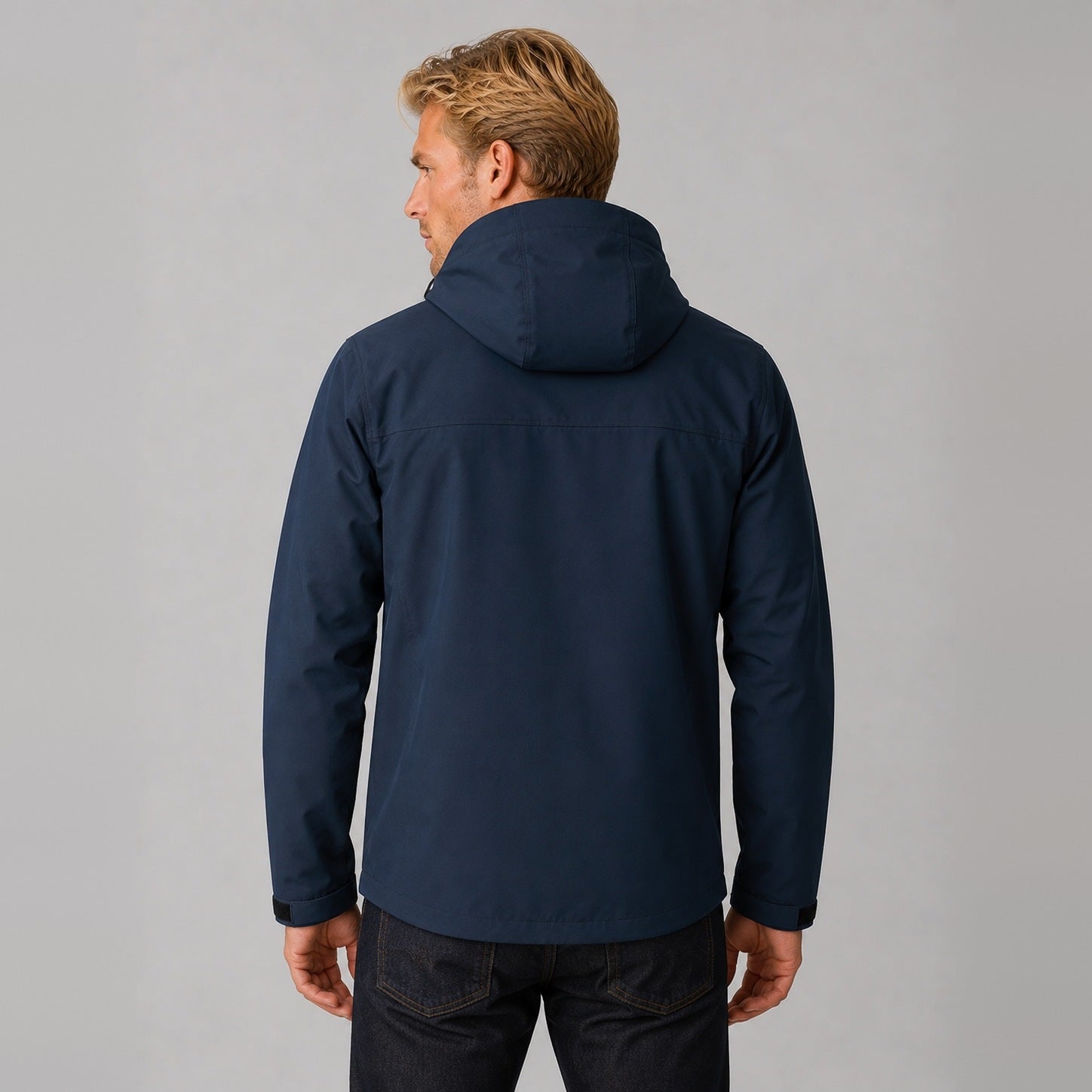 Navy hooded jacket worn by man, back view, zip pockets visible | Chaps London