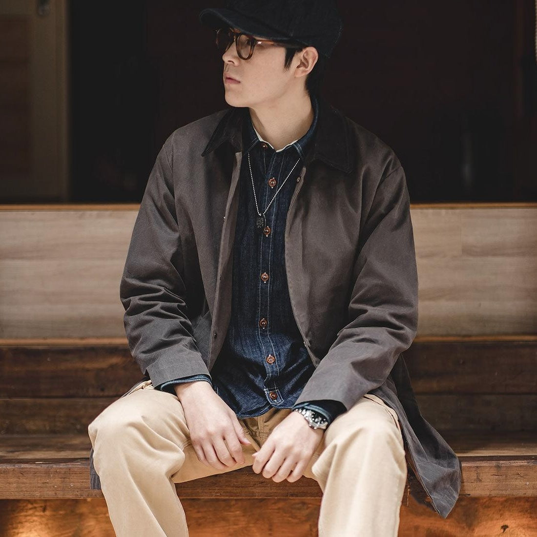 Man wearing brown jacket with corduroy collar over denim shirt, seated | Chaps London