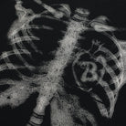 Close-up of black fabric with silver ribcage and spine print design | Chaps London