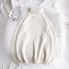 Cream knit turtleneck sweater laid flat on white bedding, folded | Chaps London