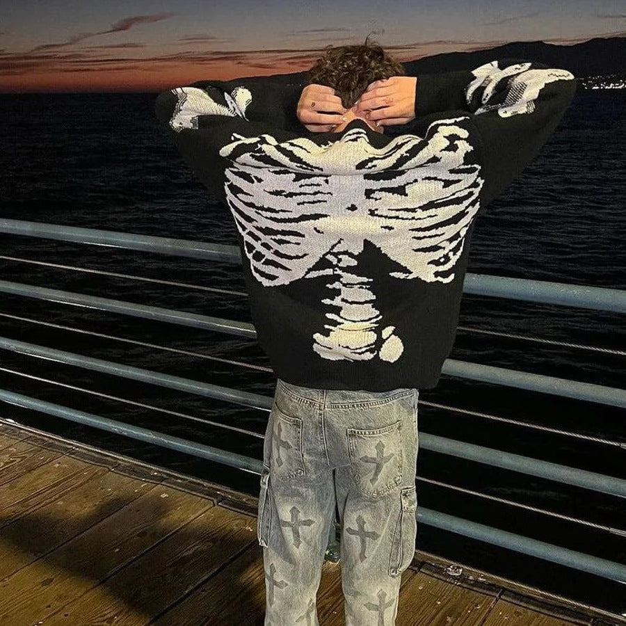 Black knit sweater with white skeleton ribcage print, worn by man outdoors | Chaps London