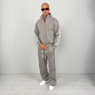 Man wearing grey half zip tracksuit with white stripes, worn outfit | Chaps London