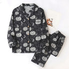Black pajama set with pumpkin and moon print, laid flat | Chaps London