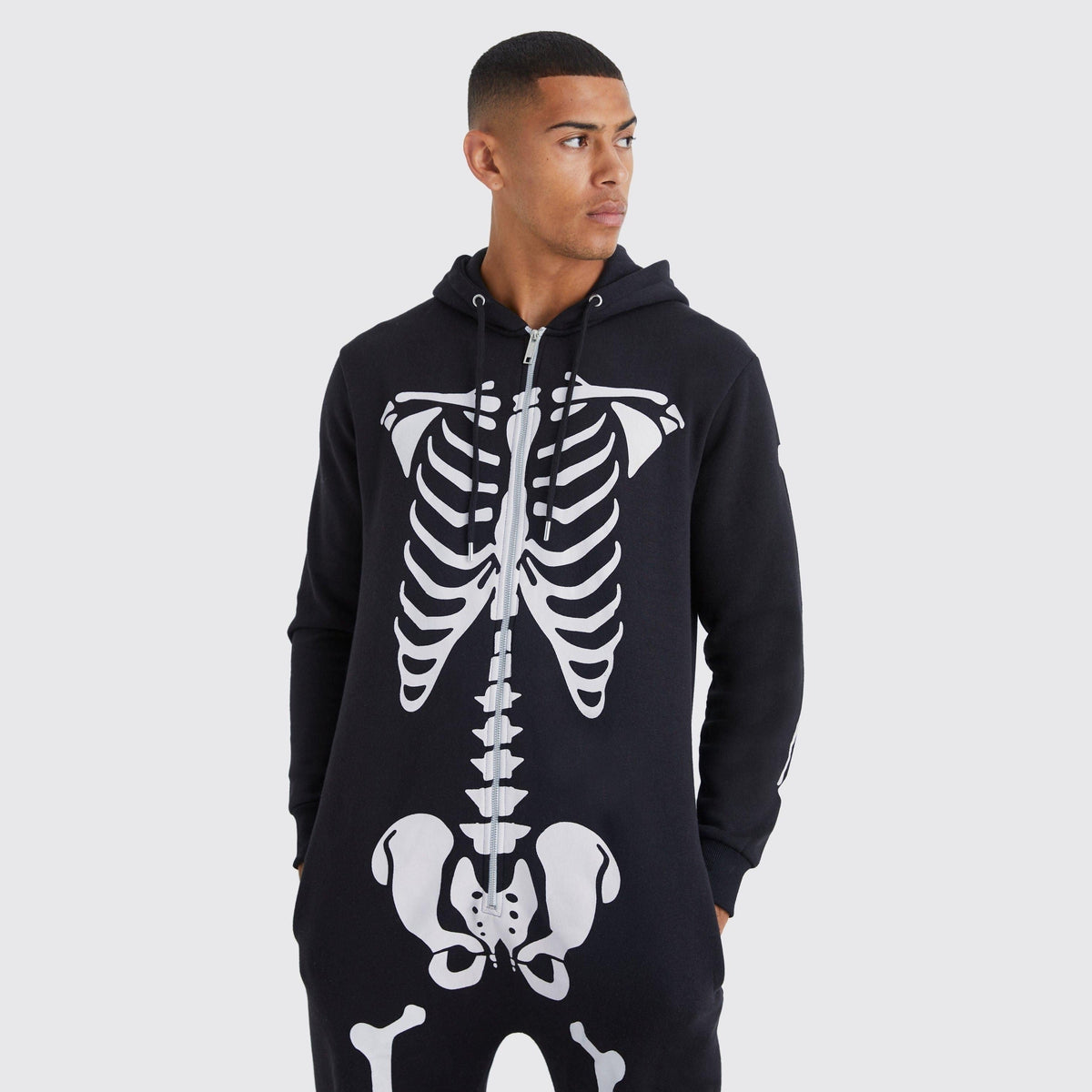 Man wearing black hooded onesie with white skeleton bone print design | Chaps London