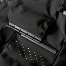 Black jacket closeup showing zipper, pen clip, and reflective dot pattern detail | Chaps London