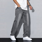 Man wearing gray washed wide-leg denim jeans with white sneakers | Chaps London