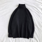 Black knit turtleneck sweater with ribbed cuffs, laid flat on fabric | Chaps London