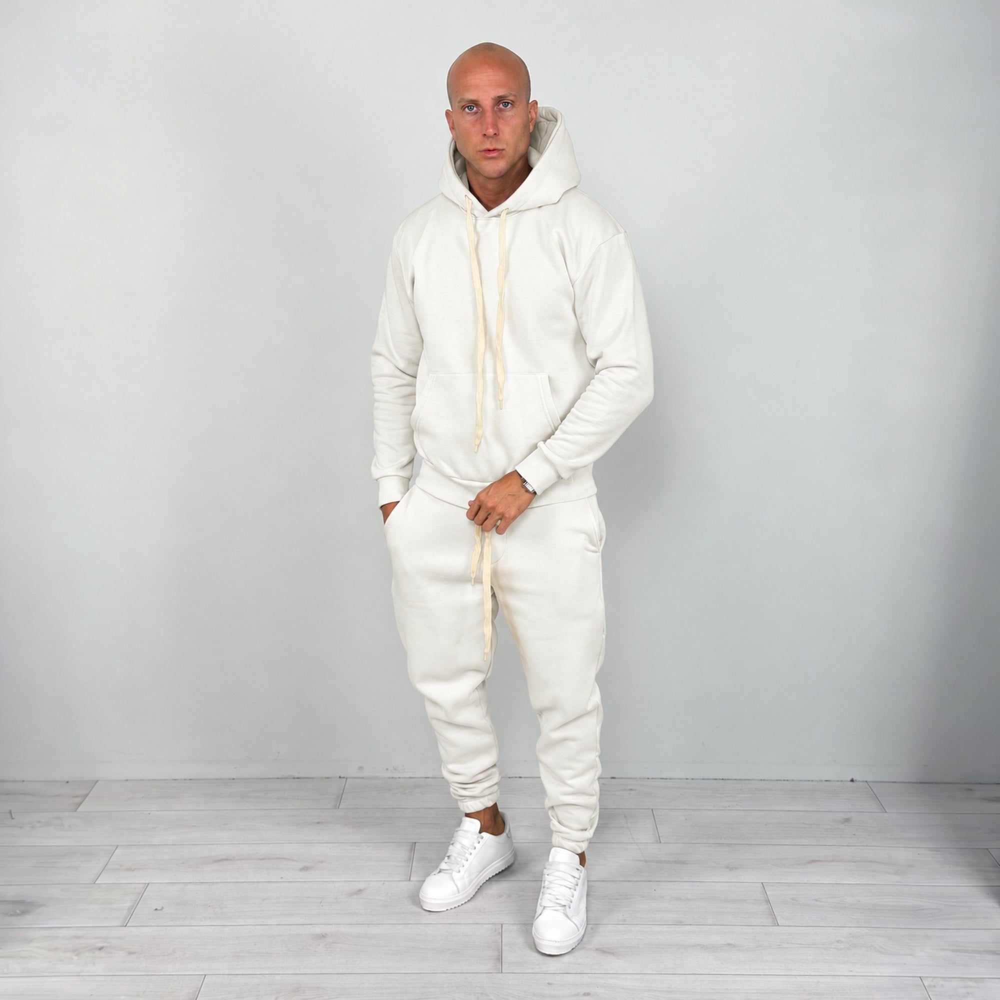 Man wearing cream hoodie and matching cuffed joggers with white sneakers | Chaps London