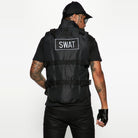 Black SWAT tactical vest worn by man, fingerless gloves, cap, rear view | Chaps London