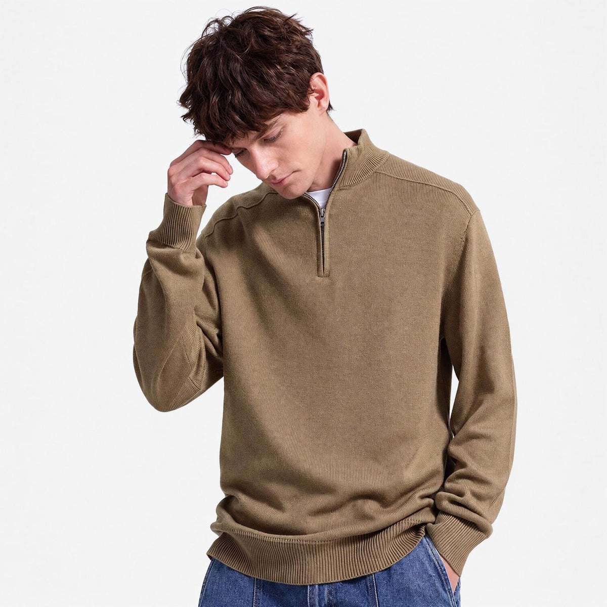 Man wearing olive green half-zip jumper with blue jeans, worn casually | Chaps London