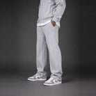 Light grey tracksuit pants worn by person, paired with grey sneakers | Chaps London