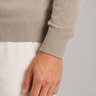 Beige fine knit sweater cuff detail, worn by person, close-up view | Chaps London