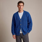 Man wearing blue ribbed knit cardigan with buttons over white t-shirt | Chaps London