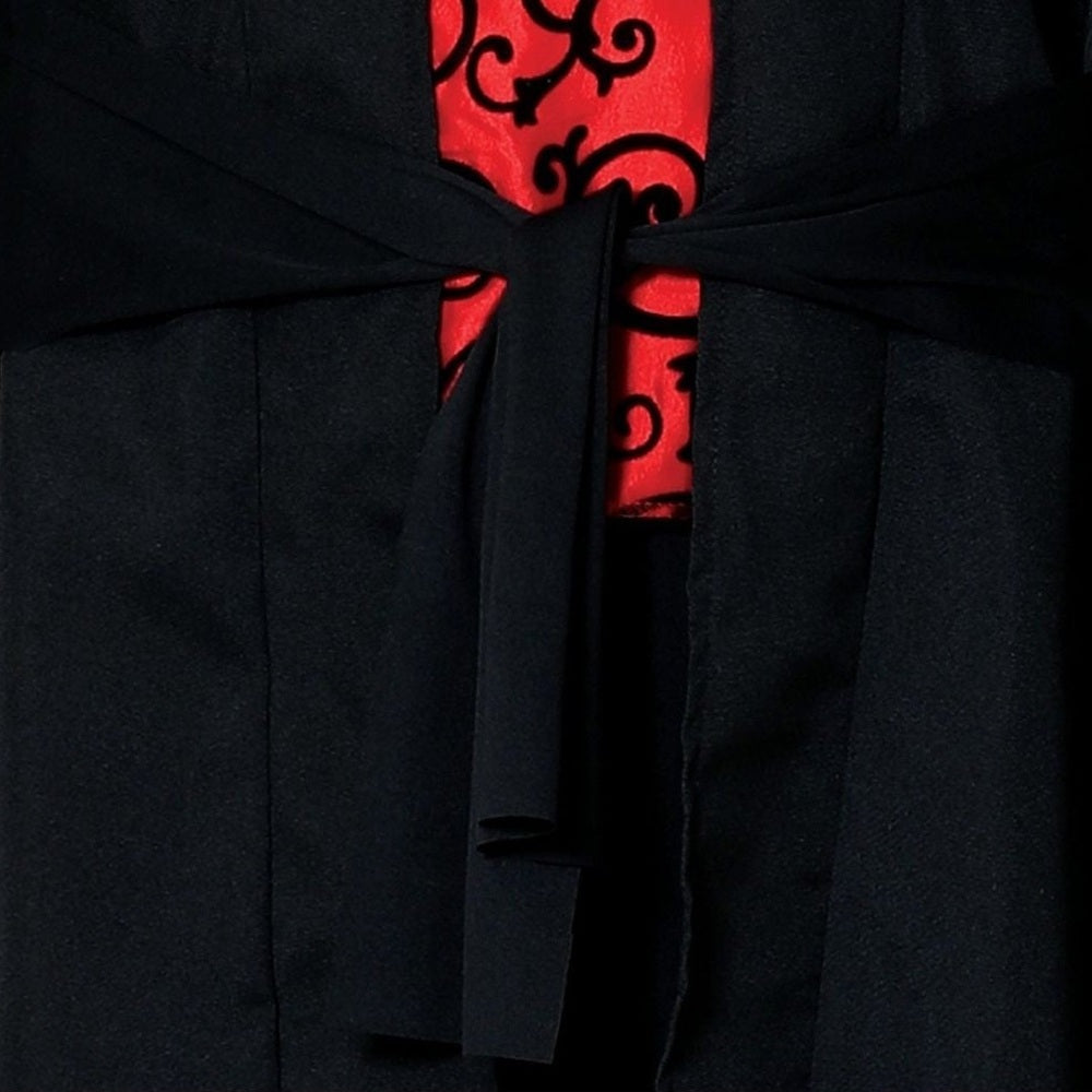 Black jacket with tie closure over red scrollwork patterned fabric, close-up view | Chaps London