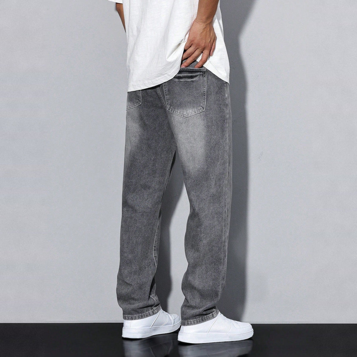 Man wearing gray washed denim wide-leg jeans with white shirt and sneakers | Chaps London