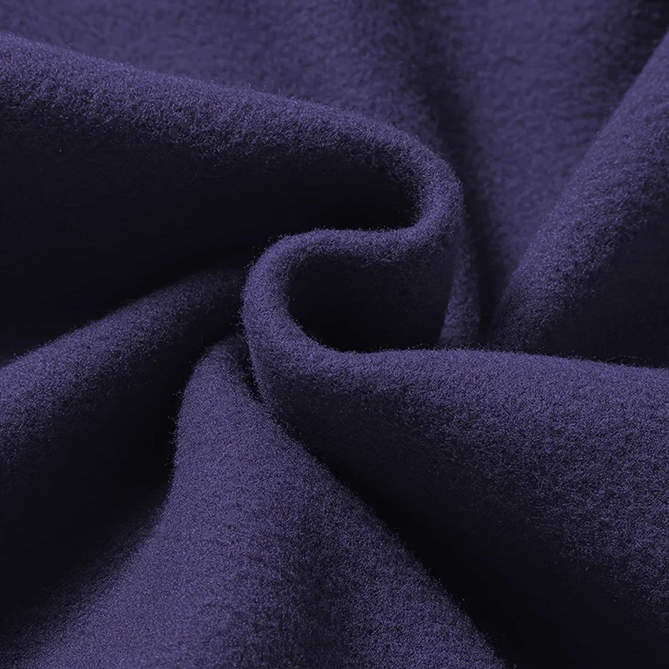 Close-up swirled navy blue fabric texture with soft folds and draping | Chaps London