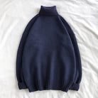 Navy blue oversized turtleneck sweater with ribbed knit, laid flat on fabric | Chaps London