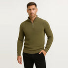 Man wearing olive green waffle knit quarter zip sweater with black pants | Chaps London