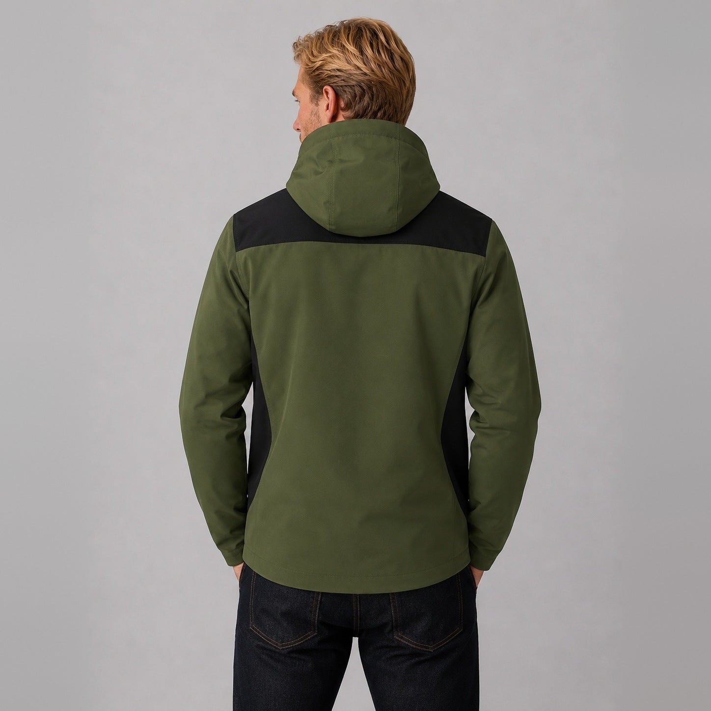 Green hooded jacket with black panels, worn by man from behind | Chaps London