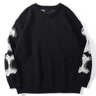 Black knit sweater with white bone pattern on sleeves, worn flat | Chaps London