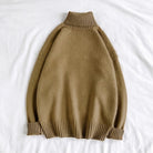 Olive green oversized turtleneck sweater, ribbed knit, laid flat on fabric | Chaps London