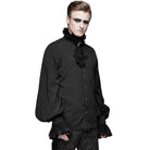 Black gothic shirt with ruffled collar, worn by male model standing | Chaps London