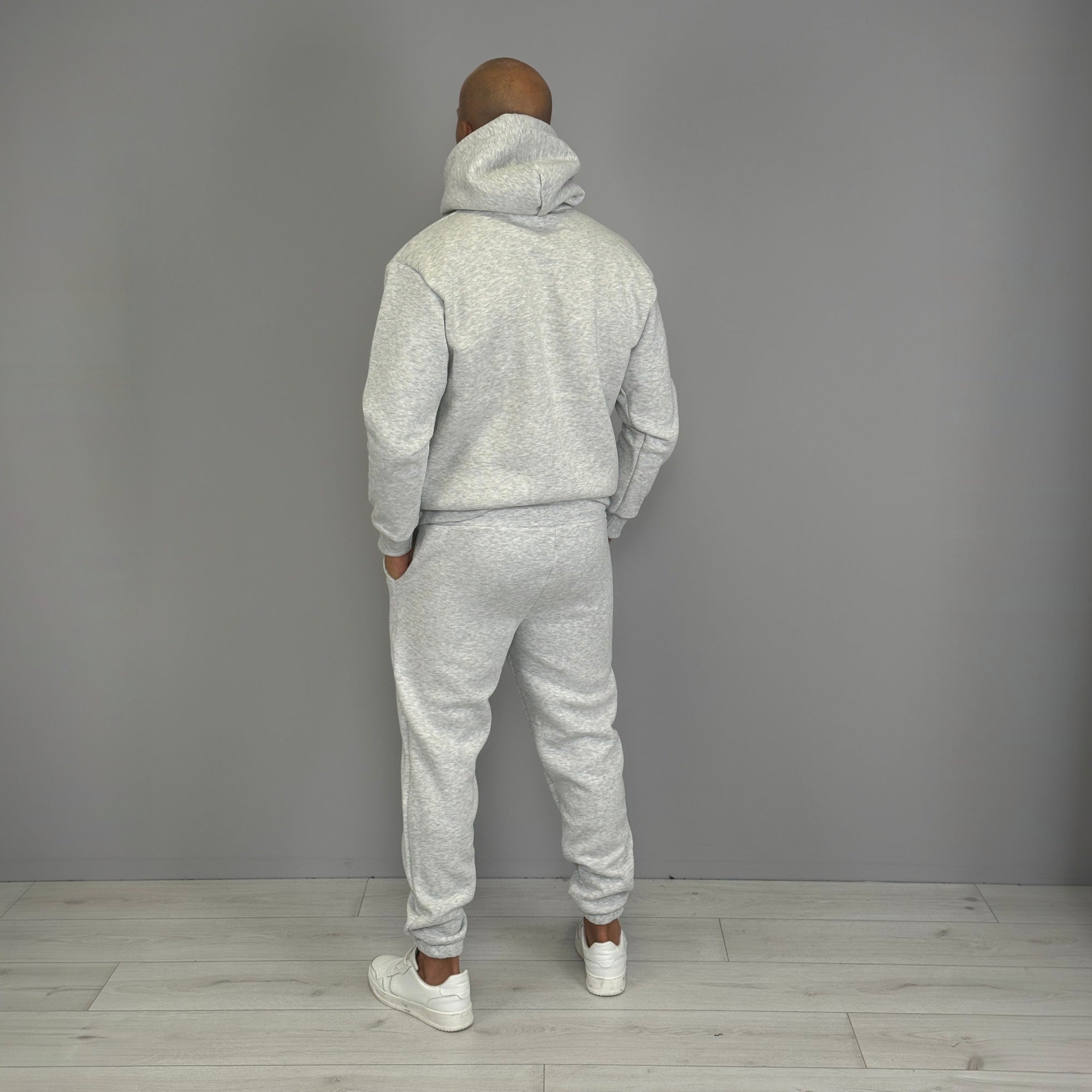 Man wearing grey hoodie and jogger tracksuit, rear view | Chaps London