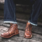 Brown lace-up ankle boots worn by person with cuffed jeans | Chaps London