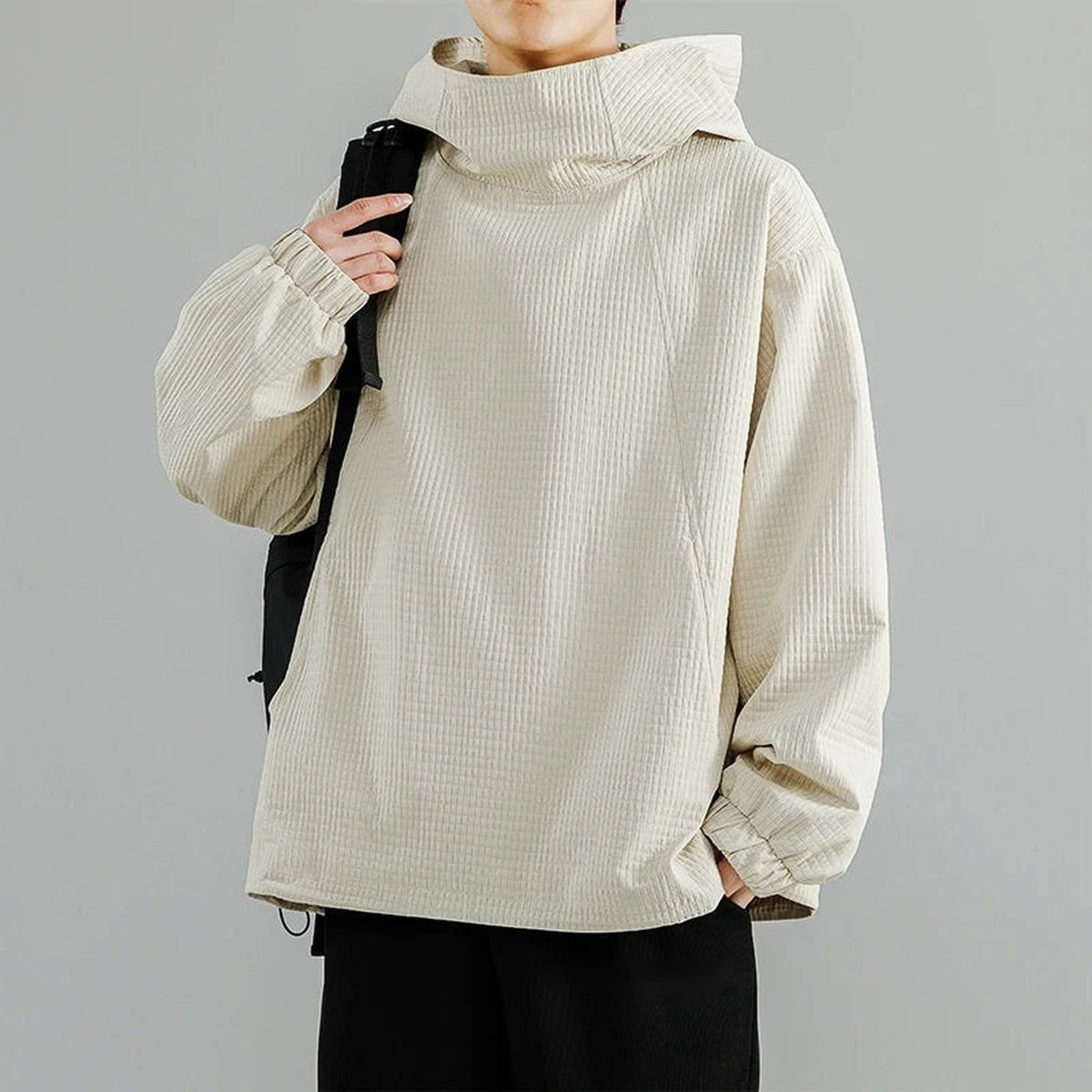 Beige waffle-texture oversized hoodie with funnel neck, worn by man with backpack | Chaps London