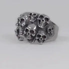 Silver-toned ring featuring multiple skull designs clustered together, shown against a plain background | Chaps London