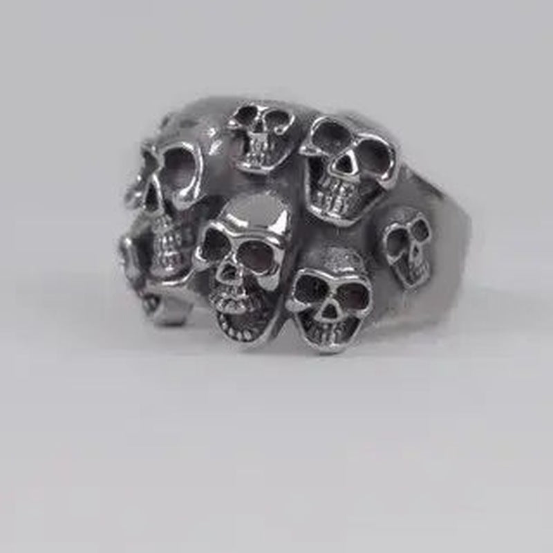 Silver-toned ring featuring multiple skull designs clustered together, shown against a plain background | Chaps London
