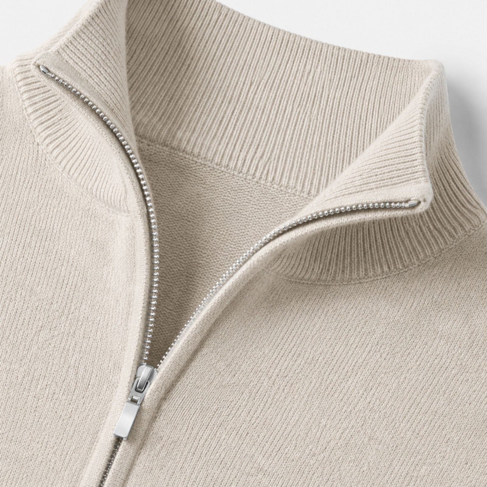 Close-up of beige quarter zip sweater with stand collar, worn | Chaps London