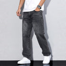 Man wearing gray washed wide-leg denim jeans with white sneakers and t-shirt | Chaps London