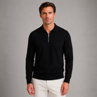 Man wearing black quarter zip knit polo jumper with white trousers | Chaps London
