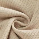 Beige textured knit fabric swirled into spiral pattern, close-up flat view | Chaps London