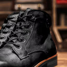 Black lace-up ankle boot with stacked heel, close-up studio shot | Chaps London