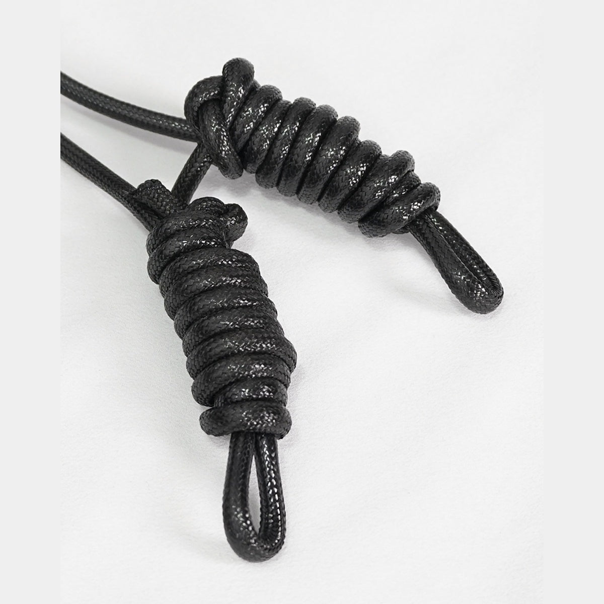 Black cord paracord lanyards with woven loop knots, shown flat | Chaps London