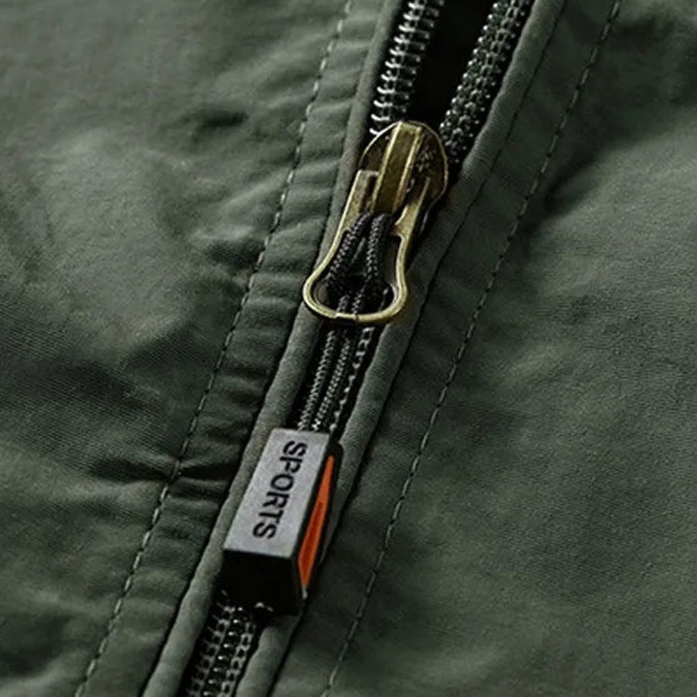 Close-up of green jacket zipper with bronze pull and fabric tab | Chaps London