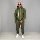 Man wearing olive green hoodie tracksuit with matching cuffed joggers, sunglasses | Chaps London