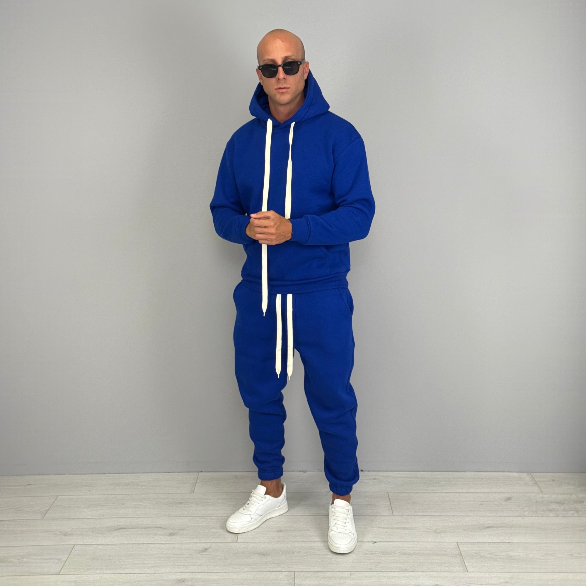 Man wearing blue hoodie and jogger tracksuit with white drawstrings, full body | Chaps London